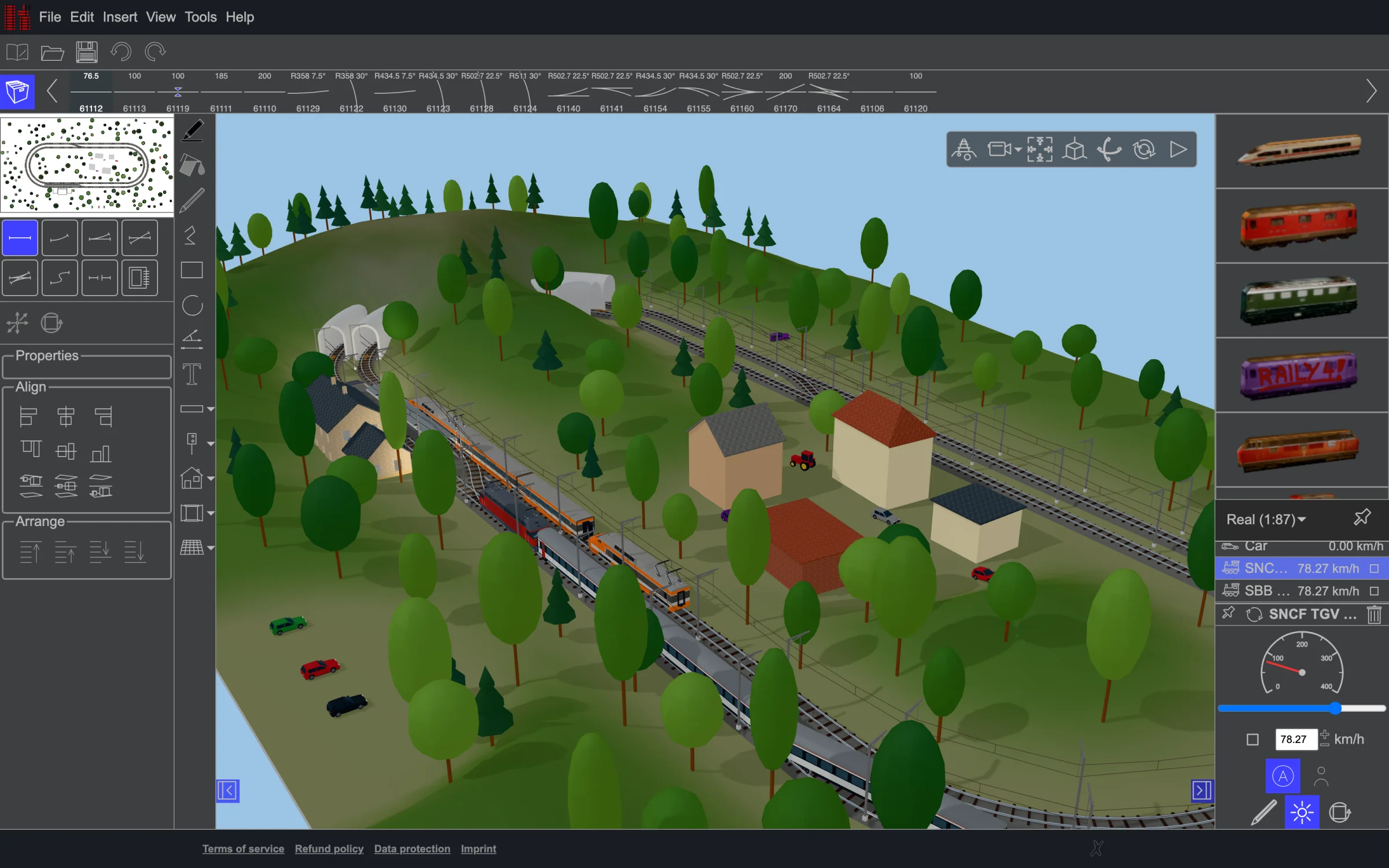 A layout with trains, a station and wooded hills in the Raily 5 editor