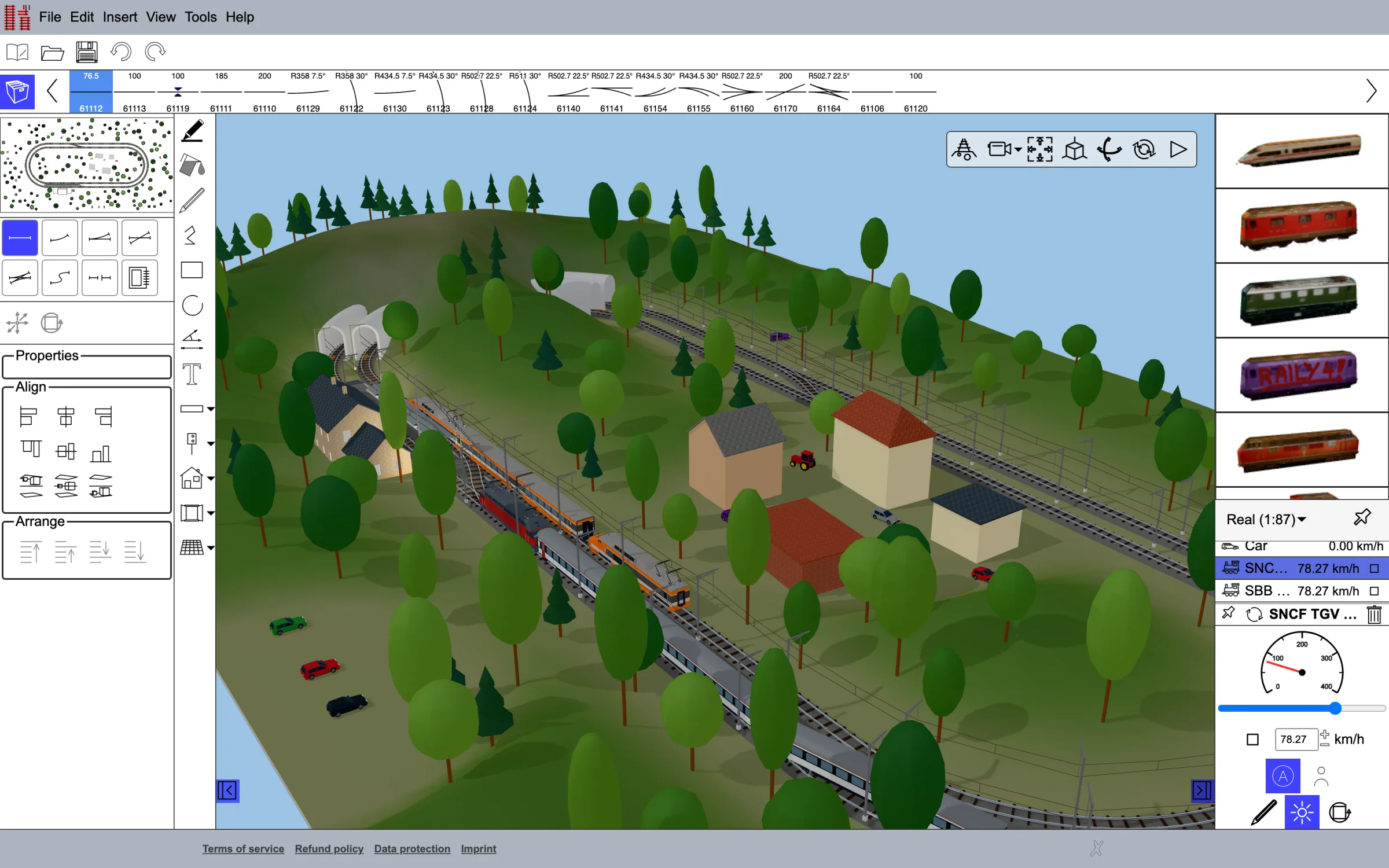 A layout with trains, a station and wooded hills in the Raily 5 editor