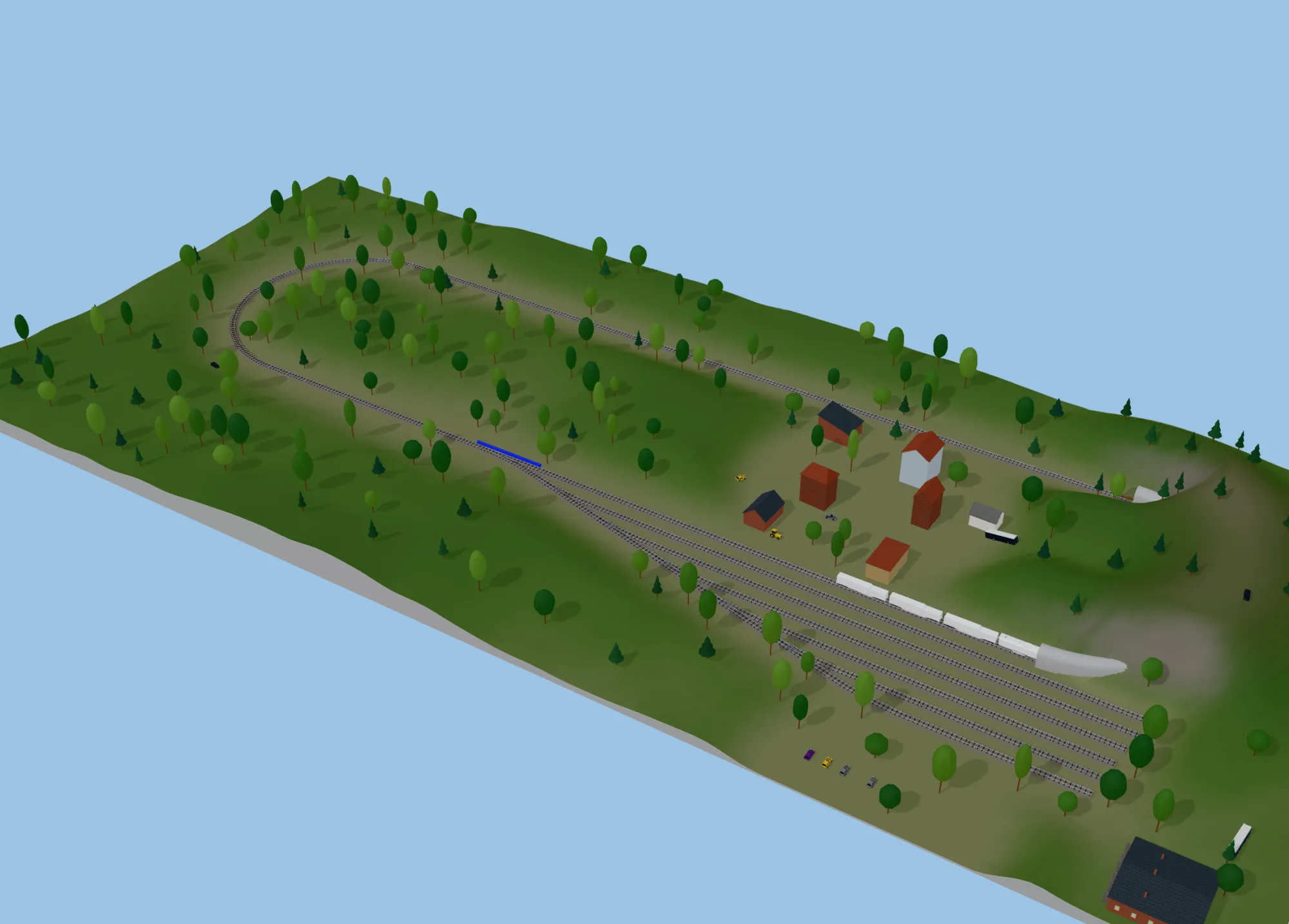 An N gauge oval with a yard running through a town